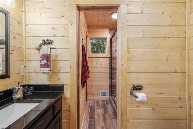 1102 Soque Wilderness Rd, Clarkesville, GA 30523 - bathroom featuring wooden walls, wood finished floors, vanity, a shower stall, and wood ceiling