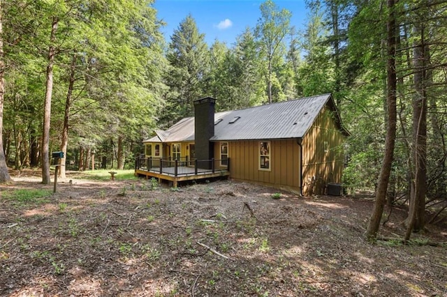 1102 Soque Wilderness Rd, Clarkesville, GA 30523 - rear view of house featuring board and batten siding, a deck, a chimney, and a forest view