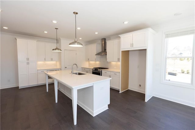 709 Dodd Ln Unit 165, Buford, GA 30518 - kitchen featuring wall chimney exhaust hood, stainless steel range with gas cooktop, a sink, white cabinets, and recessed lighting