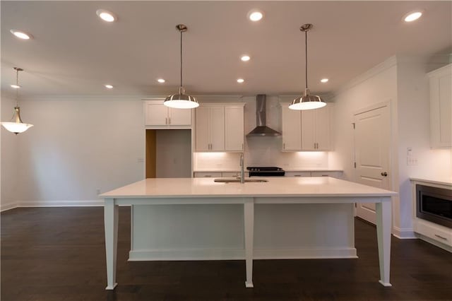 709 Dodd Ln Unit 165, Buford, GA 30518 - kitchen featuring wall chimney range hood, a sink, baseboards, white cabinetry, and ornamental molding