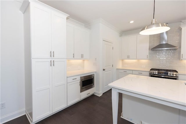 709 Dodd Ln Unit 165, Buford, GA 30518 - kitchen featuring stainless steel appliances, wall chimney range hood, white cabinetry, tasteful backsplash, and dark wood-style flooring