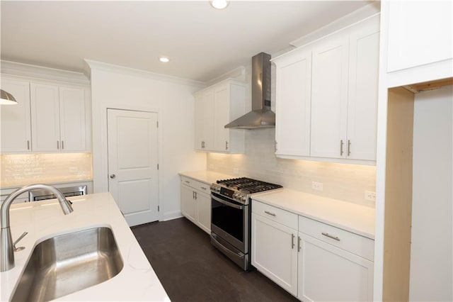 709 Dodd Ln Unit 165, Buford, GA 30518 - kitchen with wall chimney range hood, stainless steel gas stove, a sink, white cabinetry, and light countertops