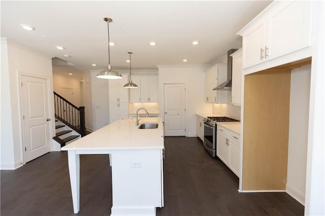 709 Dodd Ln Unit 165, Buford, GA 30518 - kitchen featuring stainless steel gas stove, a sink, wall chimney range hood, backsplash, and white cabinets