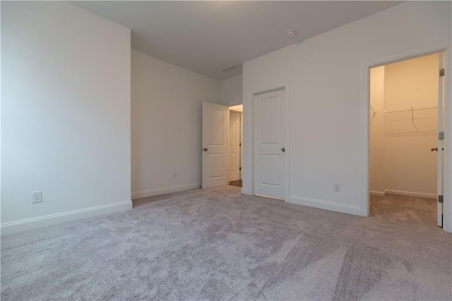 709 Dodd Ln Unit 165, Buford, GA 30518 - unfurnished bedroom featuring carpet, baseboards, and a spacious closet