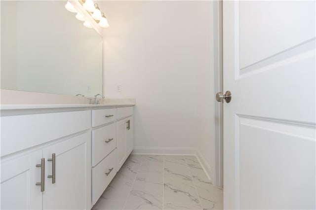 709 Dodd Ln Unit 165, Buford, GA 30518 - bathroom with marble finish flooring, vanity, baseboards, and a chandelier