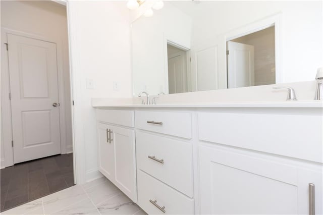 709 Dodd Ln Unit 165, Buford, GA 30518 - full bathroom with double vanity, marble finish flooring, and baseboards