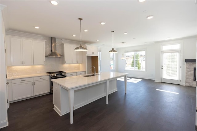 709 Dodd Ln Unit 165, Buford, GA 30518 - kitchen with wall chimney range hood, gas range, a sink, white cabinetry, and tasteful backsplash