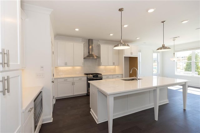709 Dodd Ln Unit 165, Buford, GA 30518 - kitchen featuring a sink, stainless steel appliances, wall chimney exhaust hood, decorative backsplash, and white cabinets
