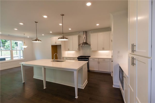 709 Dodd Ln Unit 165, Buford, GA 30518 - kitchen featuring stainless steel range oven, wall chimney exhaust hood, a sink, decorative backsplash, and baseboards