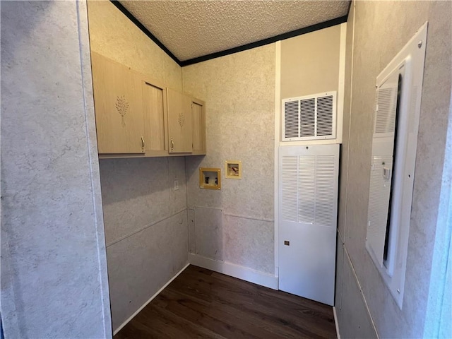 clothes washing area featuring hookup for a washing machine, dark wood-type flooring, a heating unit, and ornamental molding