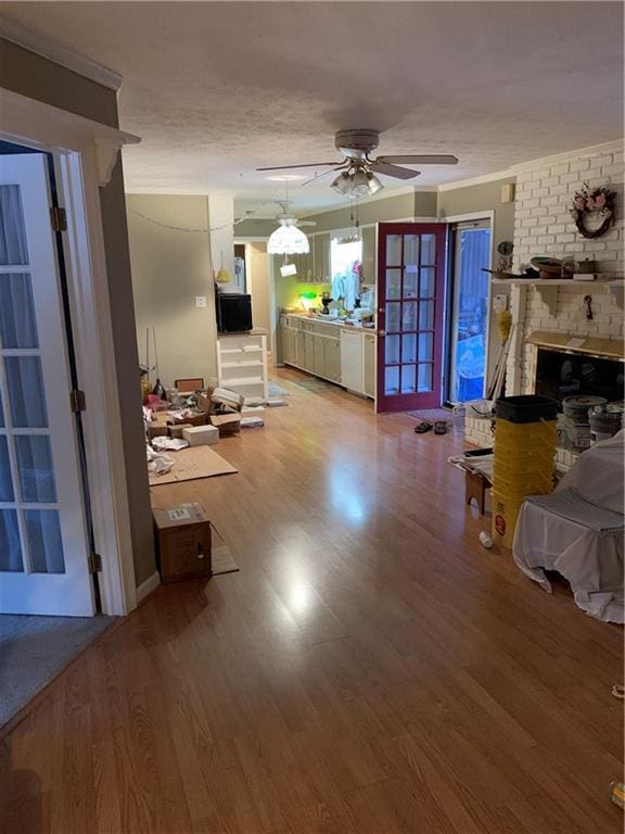 living room with a fireplace, light hardwood / wood-style floors, and ceiling fan