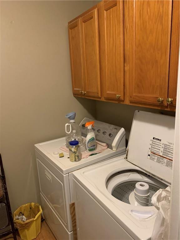 laundry area with cabinets and washer and clothes dryer