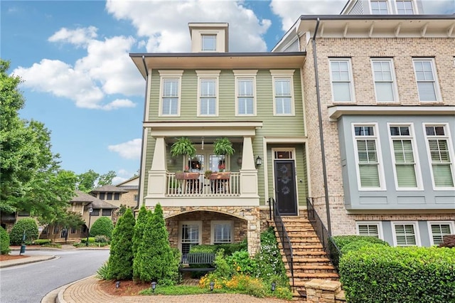 4588 Pine St SE, Smyrna, GA 30080 - view of front of house with a balcony, brick siding, and stone siding