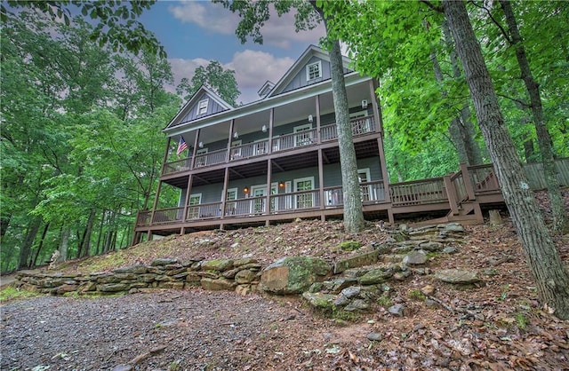 rear view of property featuring board and batten siding and a deck
