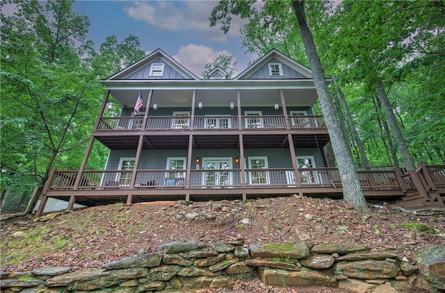 rear view of property featuring a wooden deck