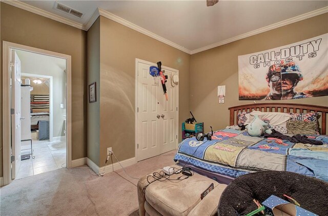 carpeted bedroom featuring ornamental molding, baseboards, and a closet