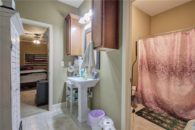 ensuite bathroom with tile patterned flooring, ceiling fan, a shower with shower curtain, and baseboards