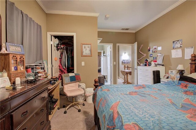 carpeted bedroom featuring ornamental molding and a spacious closet