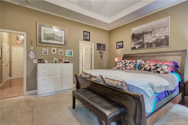 carpeted bedroom featuring baseboards and crown molding