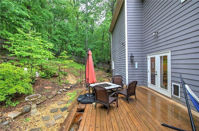 wooden deck with outdoor dining area and french doors