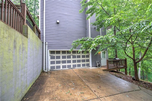view of home's exterior with a garage and concrete driveway