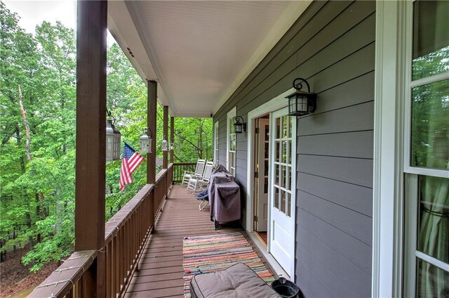 wooden terrace with a porch