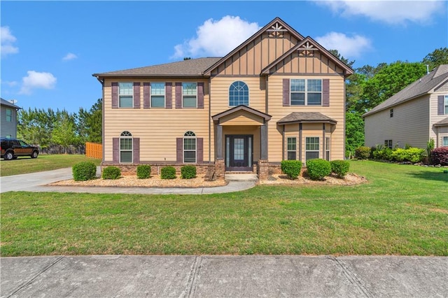 craftsman inspired home featuring board and batten siding and a front lawn
