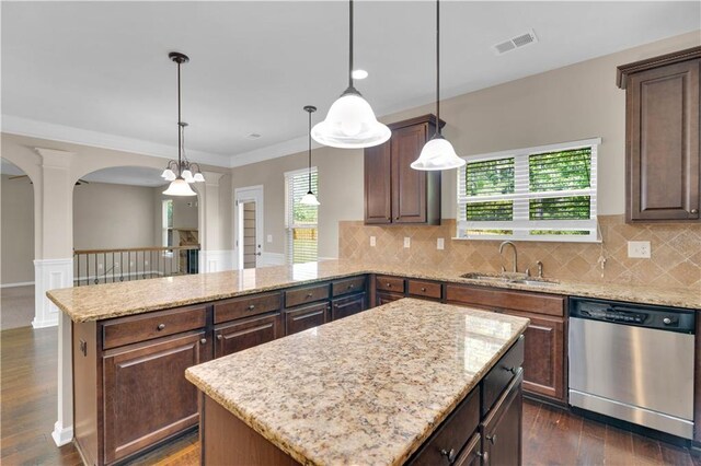 kitchen featuring a sink, dishwasher, a center island, a peninsula, and visible vents