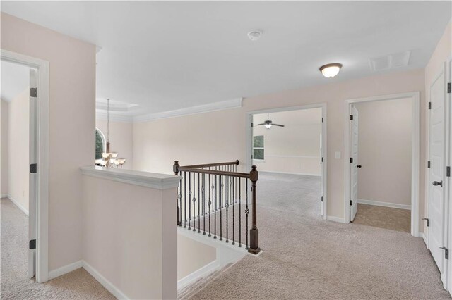 corridor featuring baseboards, visible vents, carpet flooring, and an upstairs landing