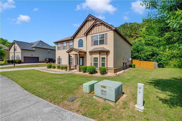 craftsman-style house with a garage, a front lawn, fence, board and batten siding, and concrete driveway