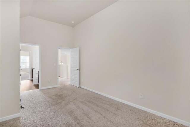 interior space with baseboards and lofted ceiling