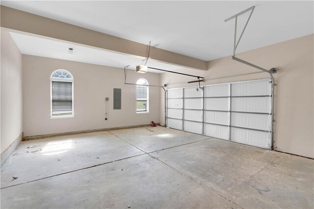 garage with a garage door opener and electric panel