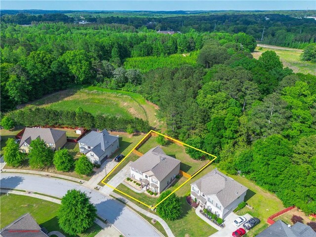 birds eye view of property featuring a residential view and a view of trees