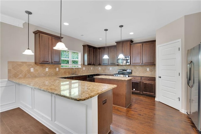 kitchen with light stone counters, dark wood finished floors, stainless steel appliances, a peninsula, and decorative backsplash