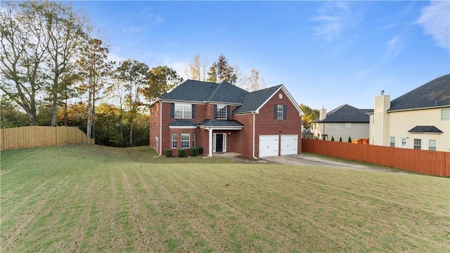 rear view of house with a yard and a garage