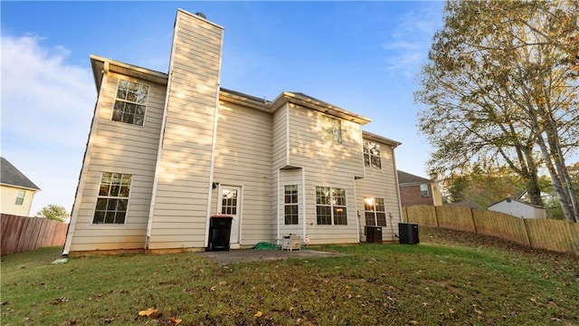 back of house with a patio area, central AC, and a yard