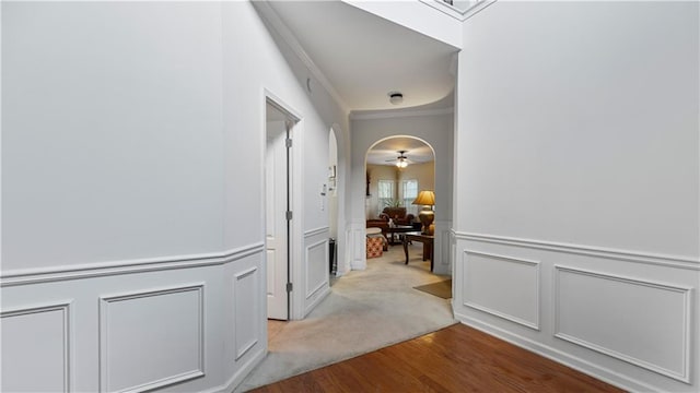 corridor with crown molding and light hardwood / wood-style floors