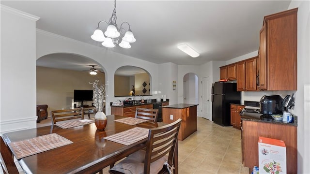 dining space featuring ceiling fan with notable chandelier and ornamental molding