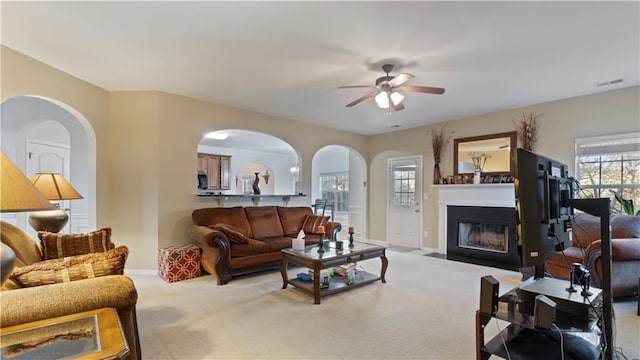 carpeted living room featuring ceiling fan