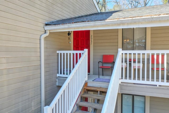 doorway to property featuring a shingled roof
