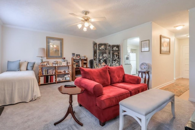 carpeted living room with ceiling fan and crown molding