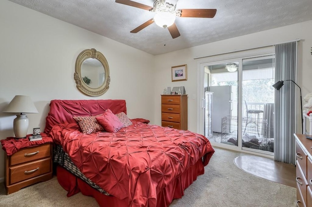 bedroom featuring a textured ceiling, a ceiling fan, access to exterior, and carpet floors