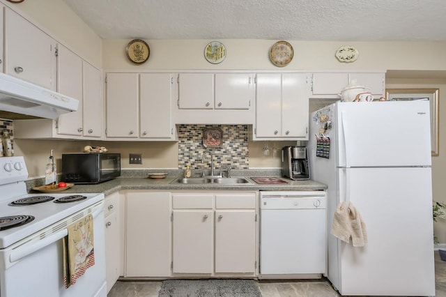 kitchen with a sink, white cabinets, under cabinet range hood, and white appliances