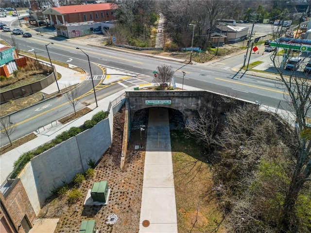 exterior space featuring sidewalks, street lights, and curbs