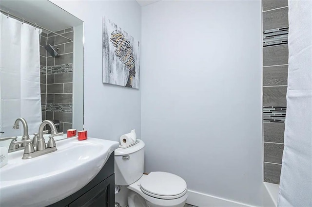 bathroom with toilet, vanity, and a shower with curtain