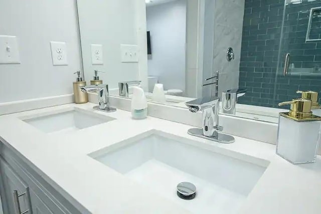 bathroom with vanity and a tile shower