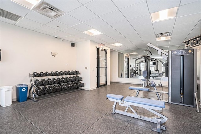 exercise room featuring a drop ceiling