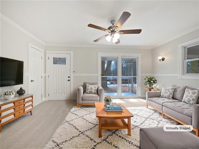 carpeted living room featuring ceiling fan and crown molding