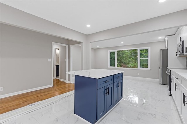 679 Creek View Dr, Lawrenceville, GA 30044 - kitchen featuring light marble finish flooring, appliances with stainless steel finishes, blue cabinetry, baseboards, and recessed lighting
