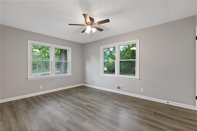 679 Creek View Dr, Lawrenceville, GA 30044 - empty room featuring a ceiling fan, dark wood-type flooring, baseboards, and a textured ceiling